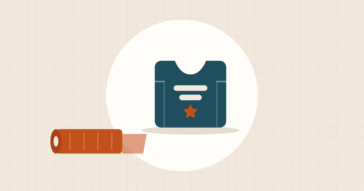 Illustration of a folded T-shirt with a vinyl design next to a roll of orange heat transfer vinyl